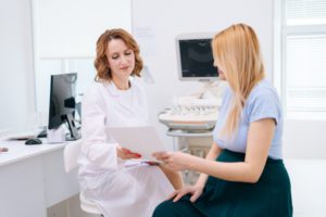 Woman asking doctor if she might be pregnant.