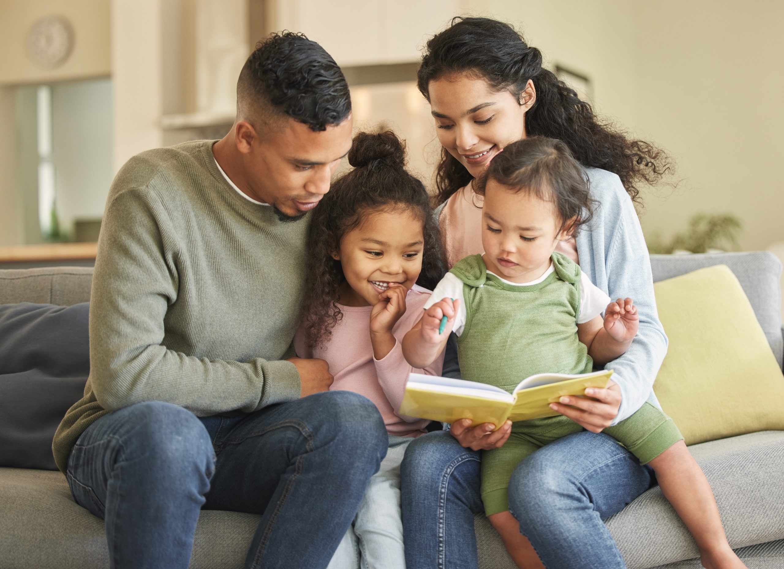 Couples hands holding paper cutout of family